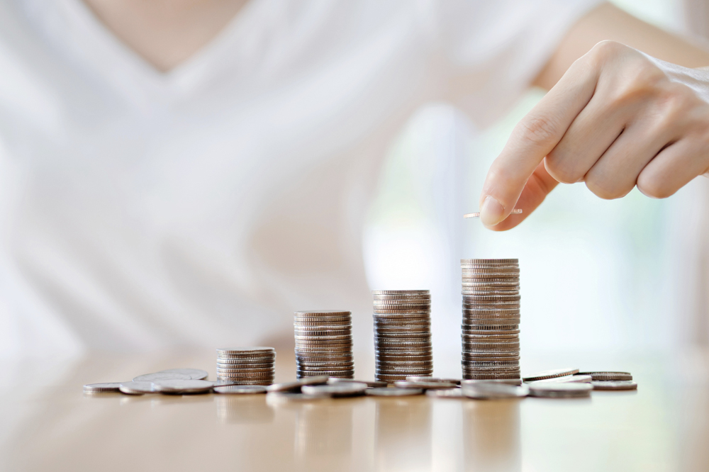 woman put coins to stack of coins woman put coins to stack of coins