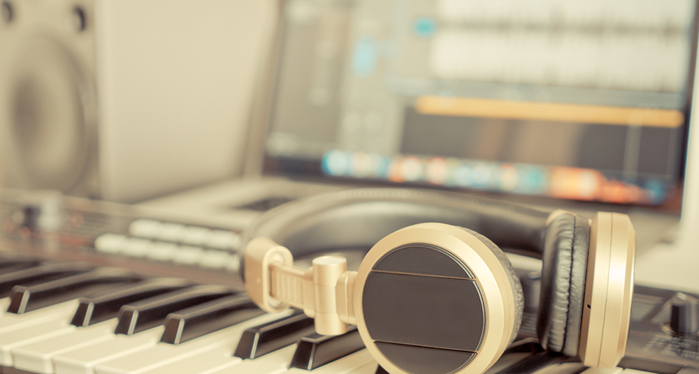 Golden Music Studio headphone lying on working desktop Golden Music Studio headphone lying on working desktop