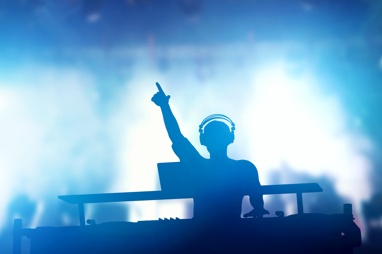 Club, disco DJ playing and mixing music for people. Nightlife Club, disco DJ playing and mixing music for crowd of happy people. Nightlife, concert lights, flares