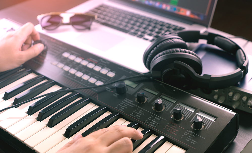Music Producer is recording Music onto a laptop Music Producer is recording Music onto a laptop