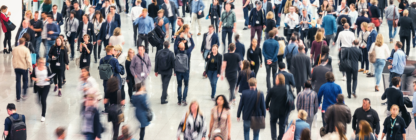 blurred Large crowd of people business people crowd at a tradeshow, banner size. ideal for websites and magazines layouts