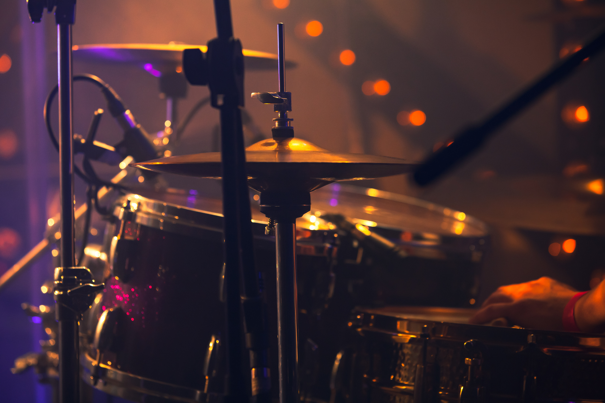 Rock drum set. Warm toned close-up photo Rock music background, drummer plays with drumsticks on rock drum set. Warm toned close-up photo, soft selective focus